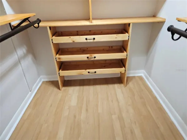 a view of walk in closet with empty racks