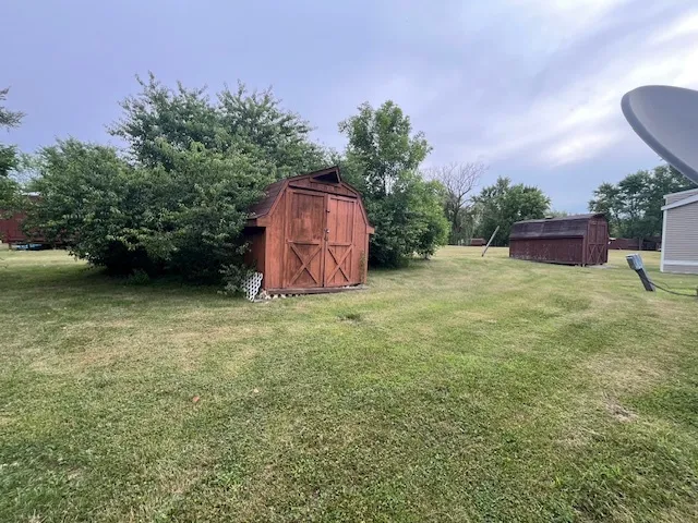 a backyard of a house with table and chairs