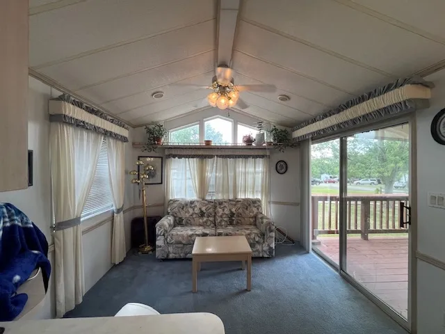 a kitchen with microwave a stove a table and chairs in it