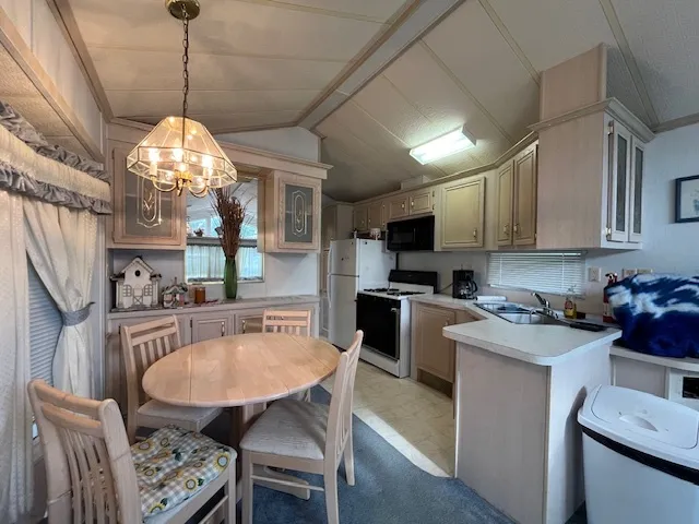 a view of a dining room with furniture and chandelier
