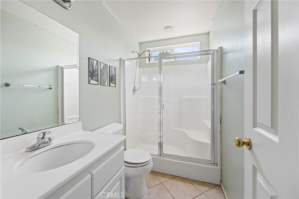 151 Ropango Way Hemet, CA 92545 - Photo 14 of 28 a bathroom with a shower sink vanity mirror and toilet
