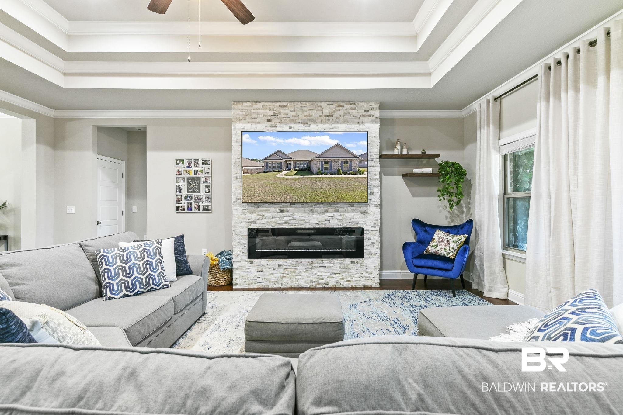 31500 Spoonbill Road Daphne, AL 36527 - Photo 10 of 85 Living room featuring ornamental molding, hardwood / wood-style floors, ceiling fan, and a stone fireplace