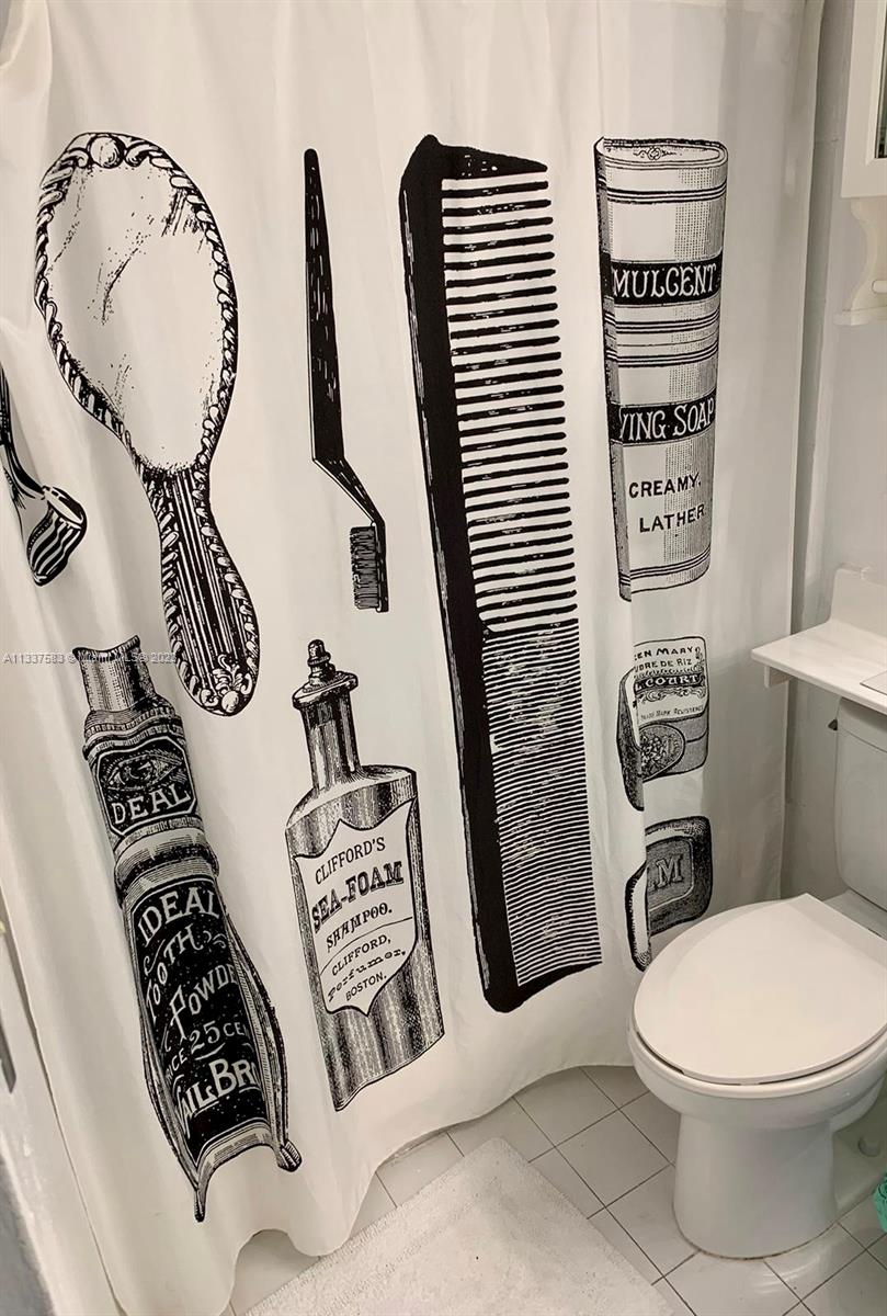 19201 Collins Avenue, Unit 906 Sunny Isles Beach, FL 33160 - Photo 12 of 19 a bathroom with a toilet a sink and mirror