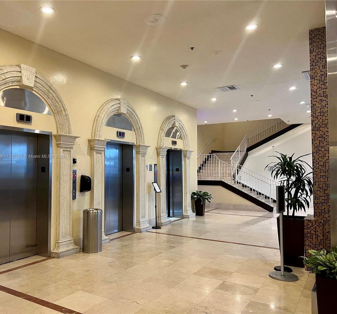 19201 Collins Avenue, Unit 906 Sunny Isles Beach, FL 33160 - Photo 15 of 19 a view of entryway with a floor to ceiling window and potted plants