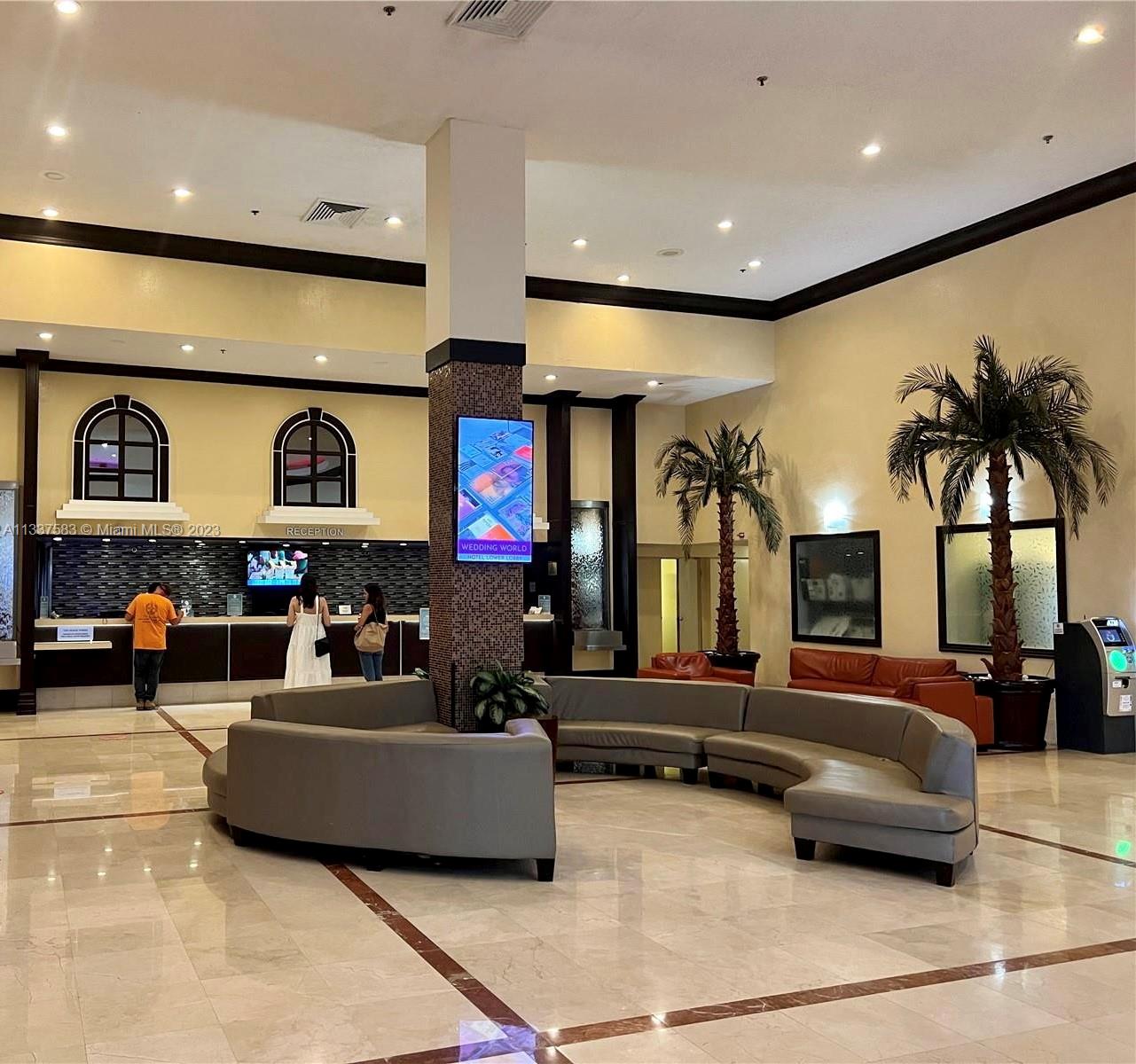 19201 Collins Avenue, Unit 906 Sunny Isles Beach, FL 33160 - Photo 16 of 19 a living room with fireplace furniture and a large window