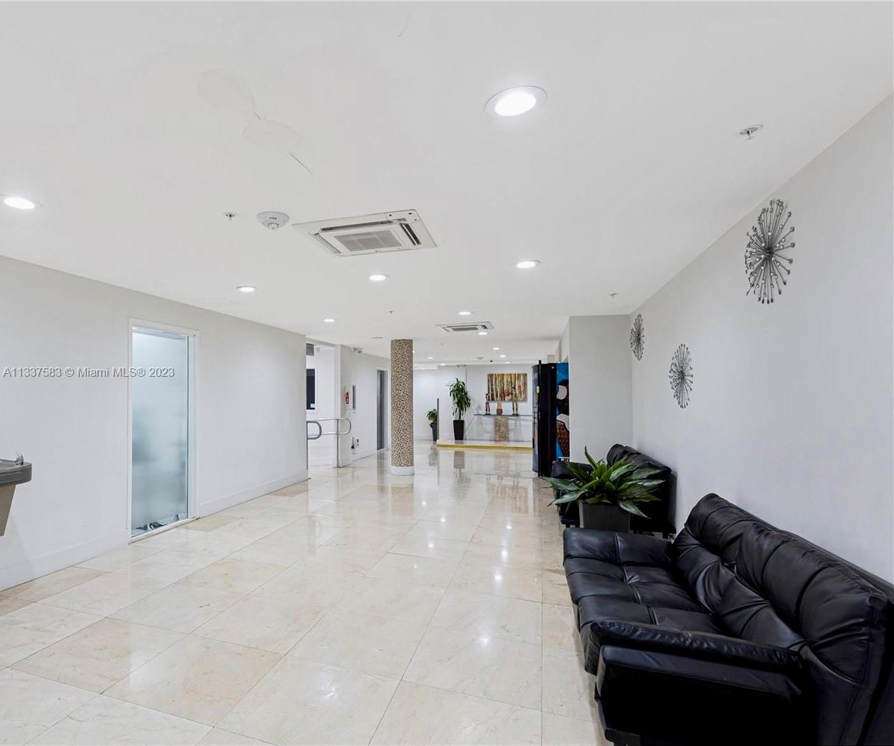 19201 Collins Avenue, Unit 906 Sunny Isles Beach, FL 33160 - Photo 18 of 19 a living room with furniture and a couch