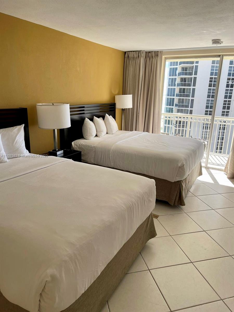 19201 Collins Avenue, Unit 906 Sunny Isles Beach, FL 33160 - Photo 8 of 19 a bedroom with bed and a window