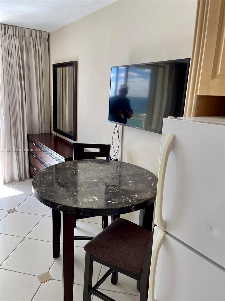 19201 Collins Avenue, Unit 906 Sunny Isles Beach, FL 33160 - Photo 9 of 19 a dining room with furniture and wooden floor