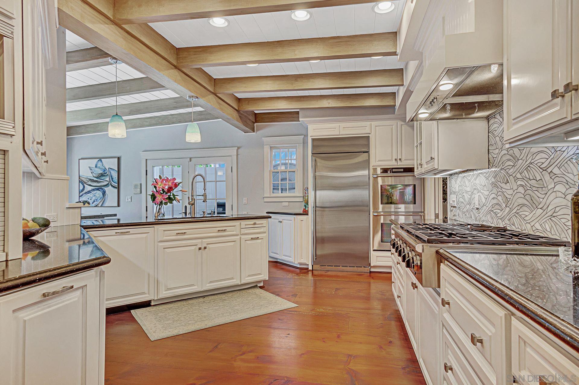 a kitchen with granite countertop a refrigerator and a stove