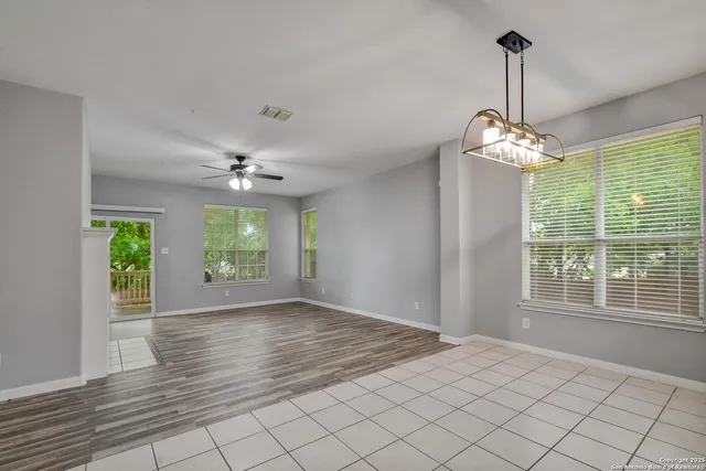 a view of a room with window wooden floor and chandelier