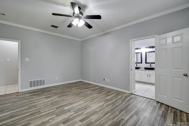 wooden floor in an empty room with a kitchen