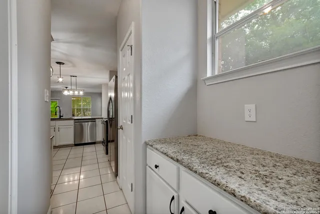 a view of kitchen with refrigerator and window