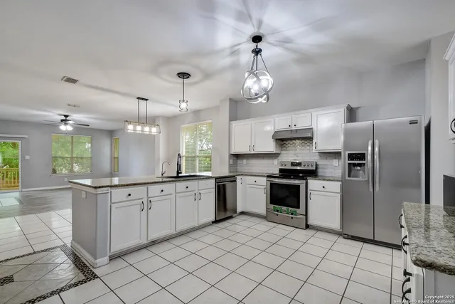 a large kitchen with cabinets and stainless steel appliances