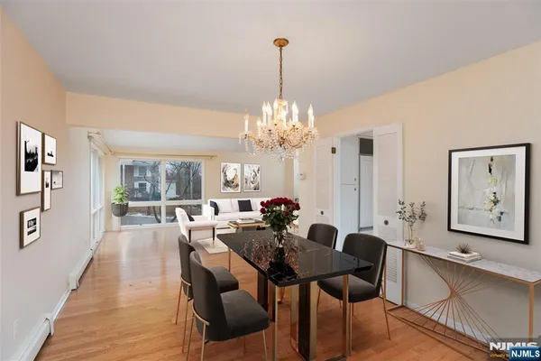 a view of a dining room with furniture and chandelier