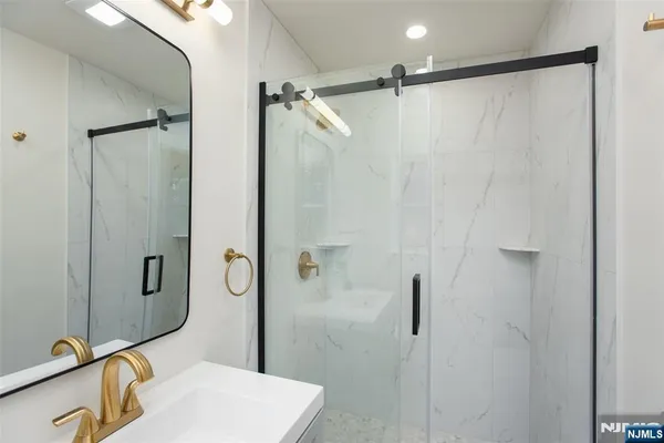 a bathroom with a shower and a sink