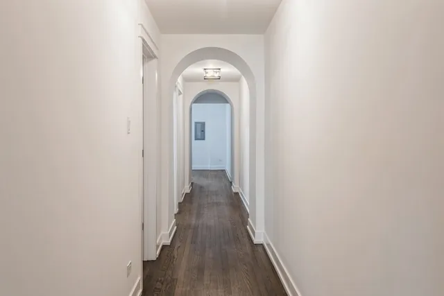 a view of a hallway with wooden floor