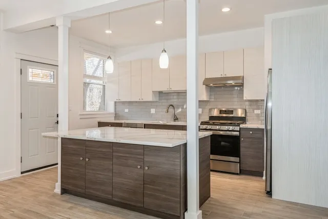 a kitchen with a refrigerator stove and sink