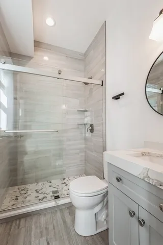 a bathroom with a toilet a sink and shower