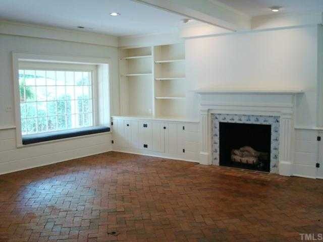 3700 St Marks Road Durham, NC 27707 - Photo 4 of 12 Family Room has cozy padded window seats, handsome brick floor, fireplace with tile surround, built-ins on both sides of fireplace and wet bar.