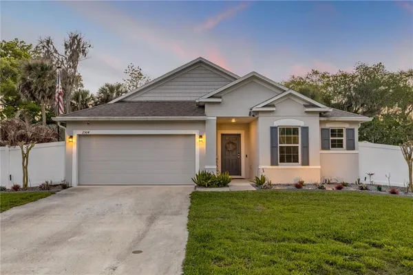 a front view of house with yard and green space