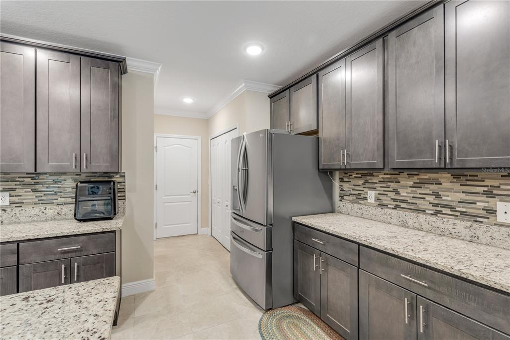 2504 Lime Tree Drive Edgewater, FL 32141 - Photo 12 of 42 a kitchen with stainless steel appliances granite countertop a refrigerator and a sink
