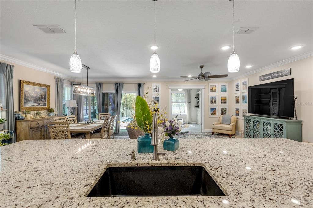 2504 Lime Tree Drive Edgewater, FL 32141 - Photo 15 of 42 a kitchen with kitchen island granite countertop a sink and a large window