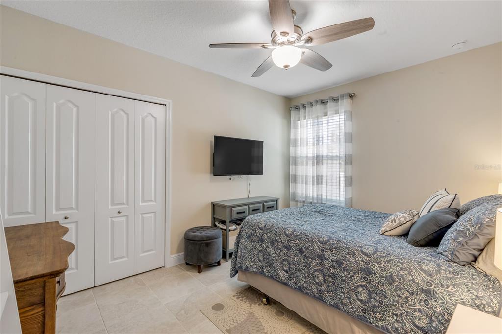 2504 Lime Tree Drive Edgewater, FL 32141 - Photo 25 of 42 a bedroom with a bed and a flat screen tv