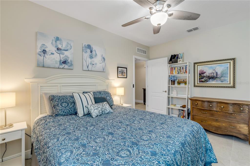 2504 Lime Tree Drive Edgewater, FL 32141 - Photo 26 of 42 a bedroom with a bed and a chandelier