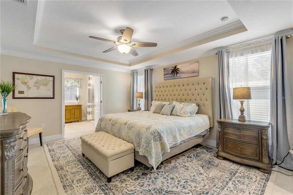 2504 Lime Tree Drive Edgewater, FL 32141 - Photo 27 of 42 a bedroom with a large bed and a couch