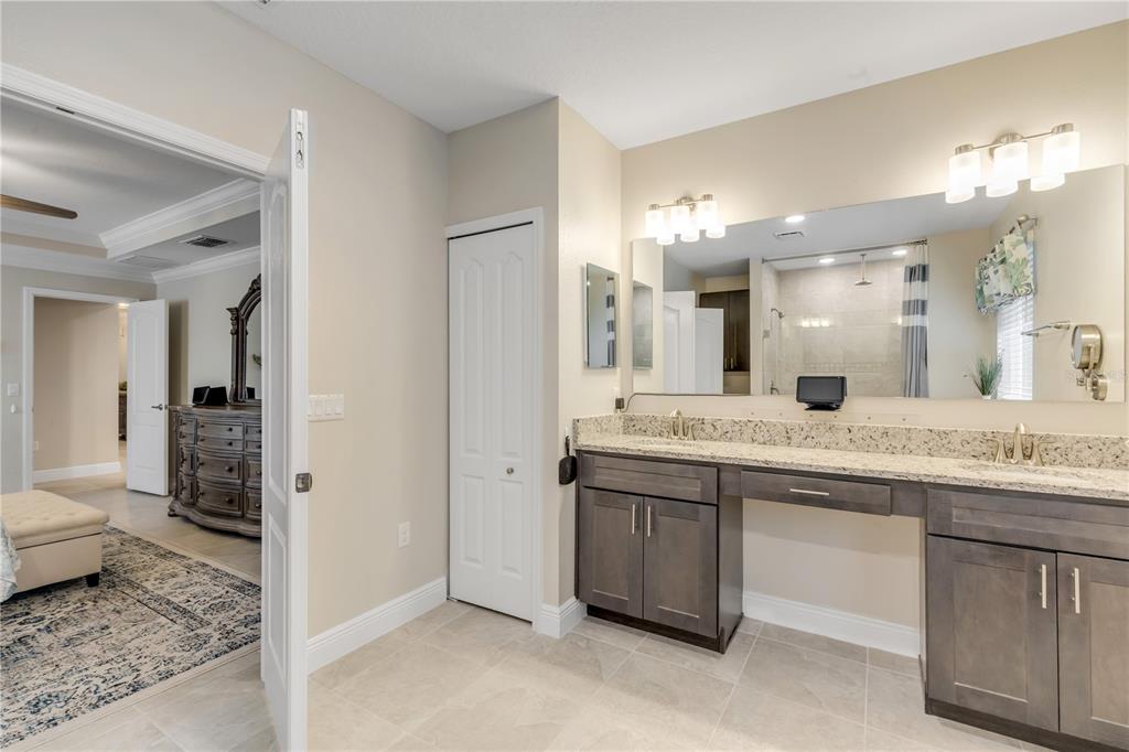 2504 Lime Tree Drive Edgewater, FL 32141 - Photo 29 of 42 a bathroom with a granite countertop sink two mirror and shower