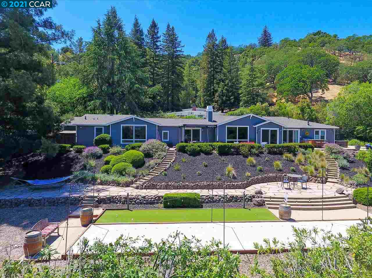 a front view of a house with swimming pool having outdoor seating