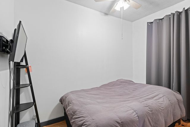 a bed room with a bed and a flat tv screen