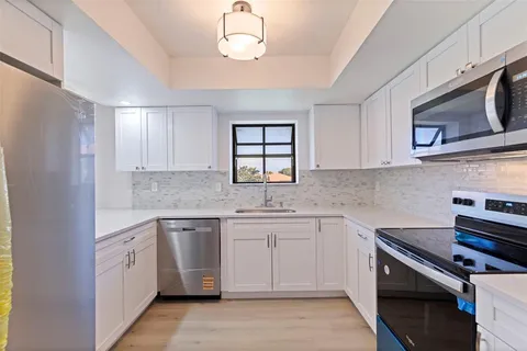 a kitchen with a sink stove and microwave