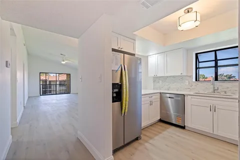 a kitchen with a refrigerator and a sink