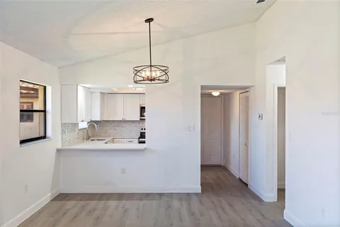 a view with a refrigerator and a sink