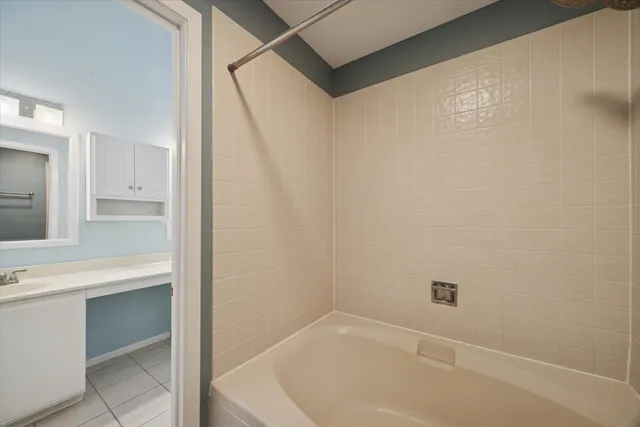 a bathroom with a bathtub and a sink