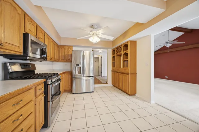 a kitchen with stainless steel appliances granite countertop a refrigerator and a stove top oven