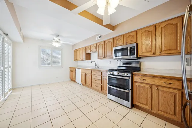 a kitchen with stainless steel appliances granite countertop a stove cabinets and microwave