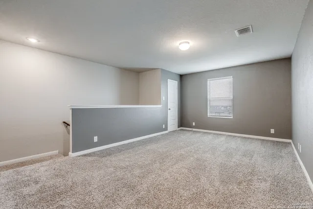 a view of an empty room and a window