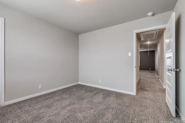 an empty room with closet and a bathroom