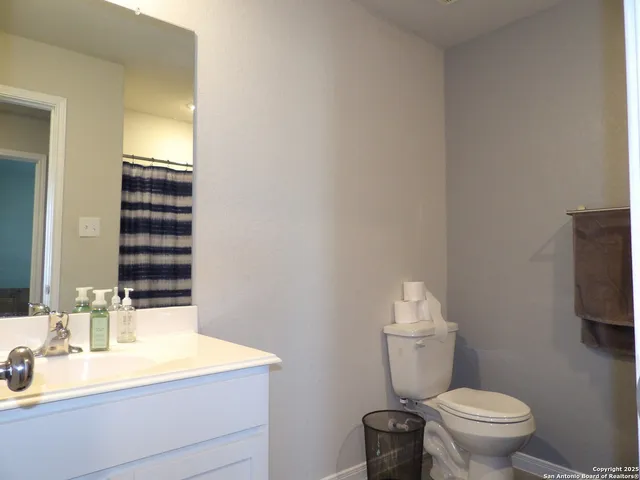 a bathroom with a sink a toilet and mirror