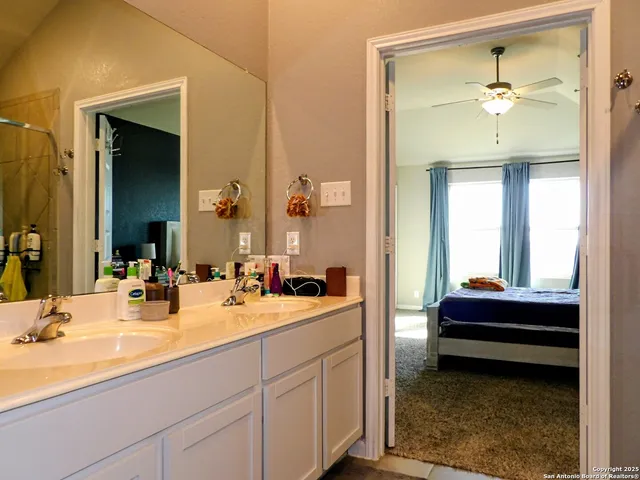 a en suite bathroom with a sink and a mirror