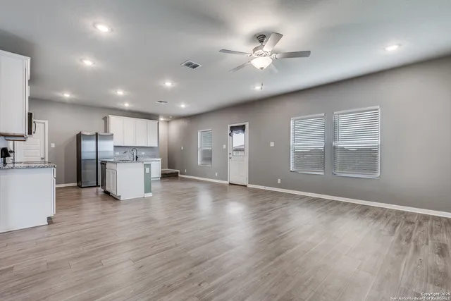 a view of kitchen with cabinets and wooden floor