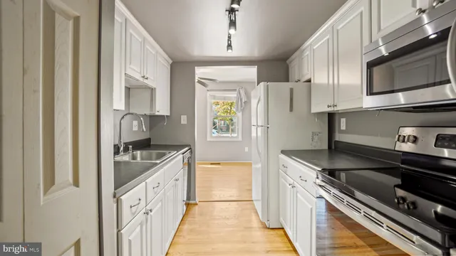 a kitchen with stainless steel appliances granite countertop a stove and a refrigerator