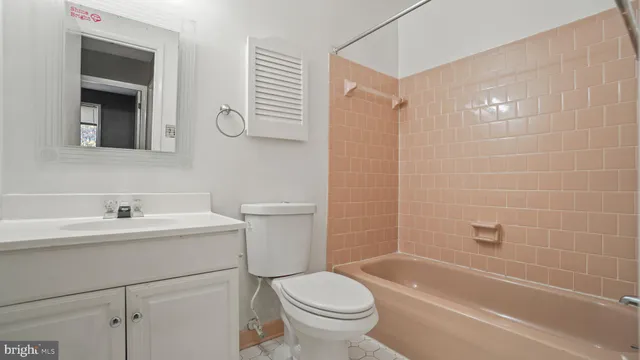 a bathroom with a sink toilet a mirror and shower