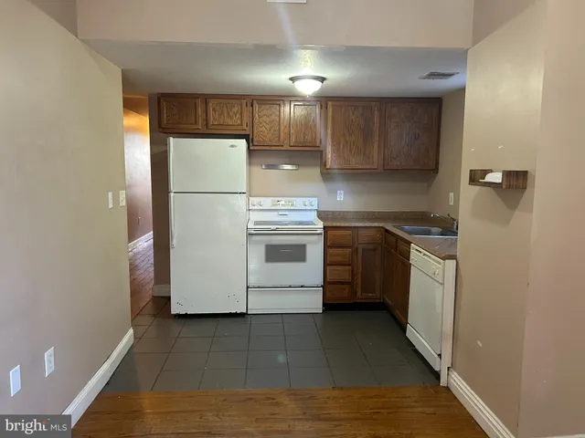 a kitchen with a refrigerator sink and cabinets