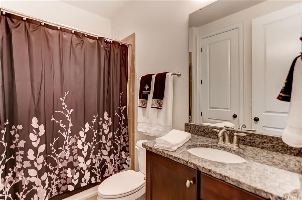 754 Revival Row Fort Mill, SC 29708 - Photo 18 of 35 a bathroom with a granite countertop sink and a mirror