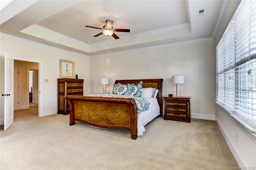 754 Revival Row Fort Mill, SC 29708 - Photo 20 of 35 a bed room with a bed and a chandelier