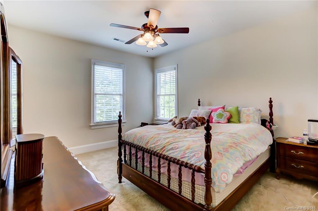 754 Revival Row Fort Mill, SC 29708 - Photo 24 of 35 a bedroom with a bed and a chandelier