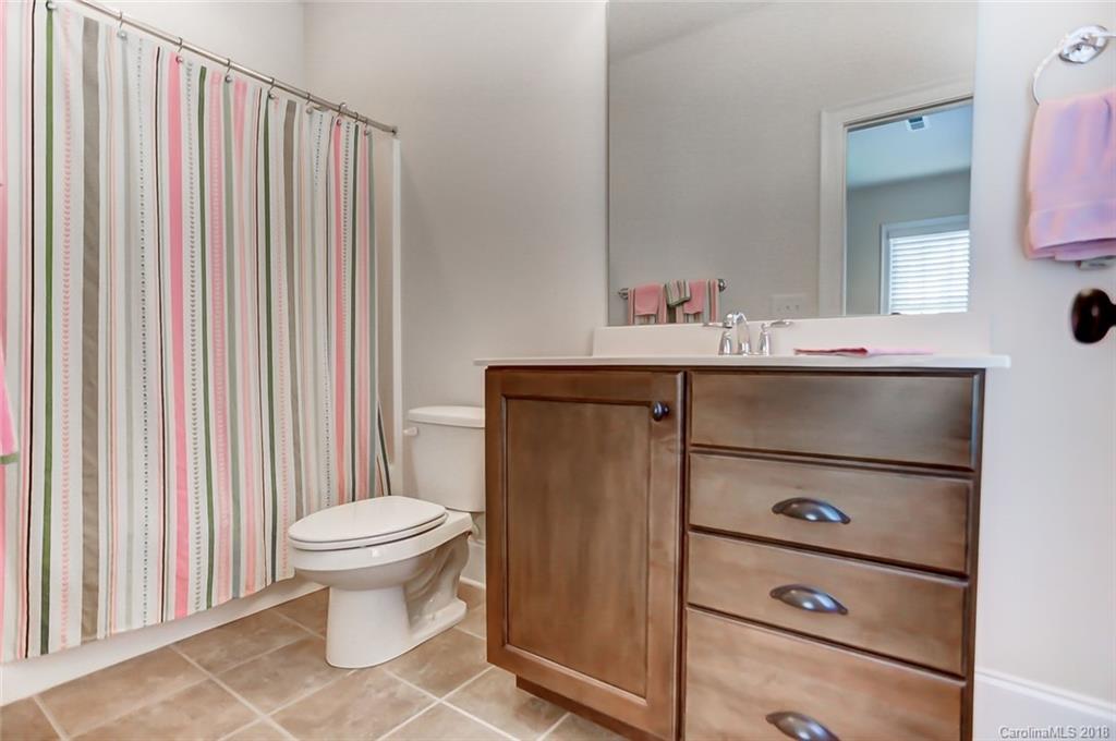 754 Revival Row Fort Mill, SC 29708 - Photo 25 of 35 a bathroom with a sink a toilet and shower curtain